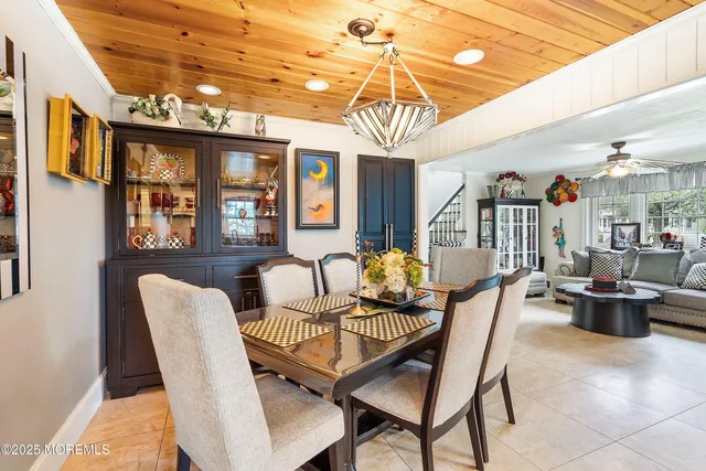 a dining room with furniture a chandelier and wooden floor