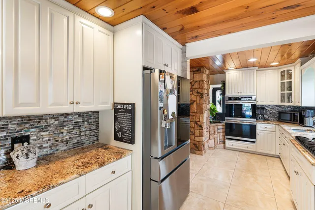 a kitchen with stainless steel appliances granite countertop a refrigerator and a sink