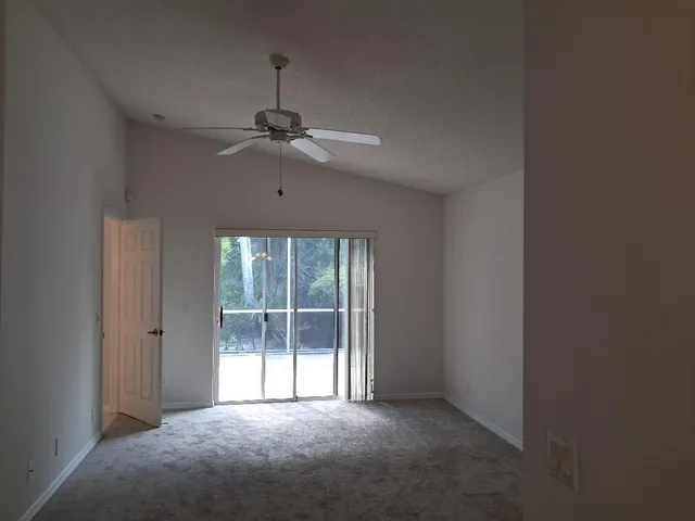 a room with a table and white chairs