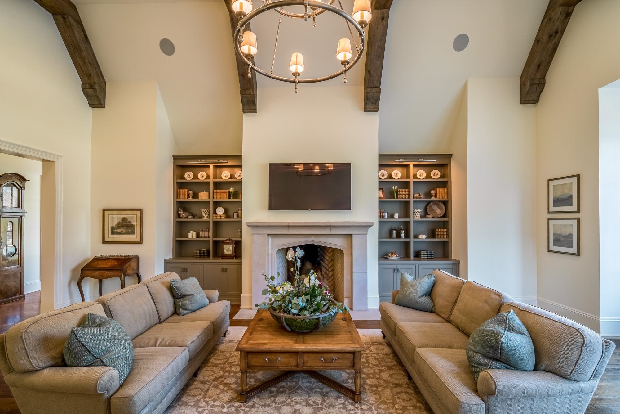 248 Dubray Manor Drive Collierville, TN 38017 - Photo 11 of 25 a living room with furniture a fireplace and a large mirror