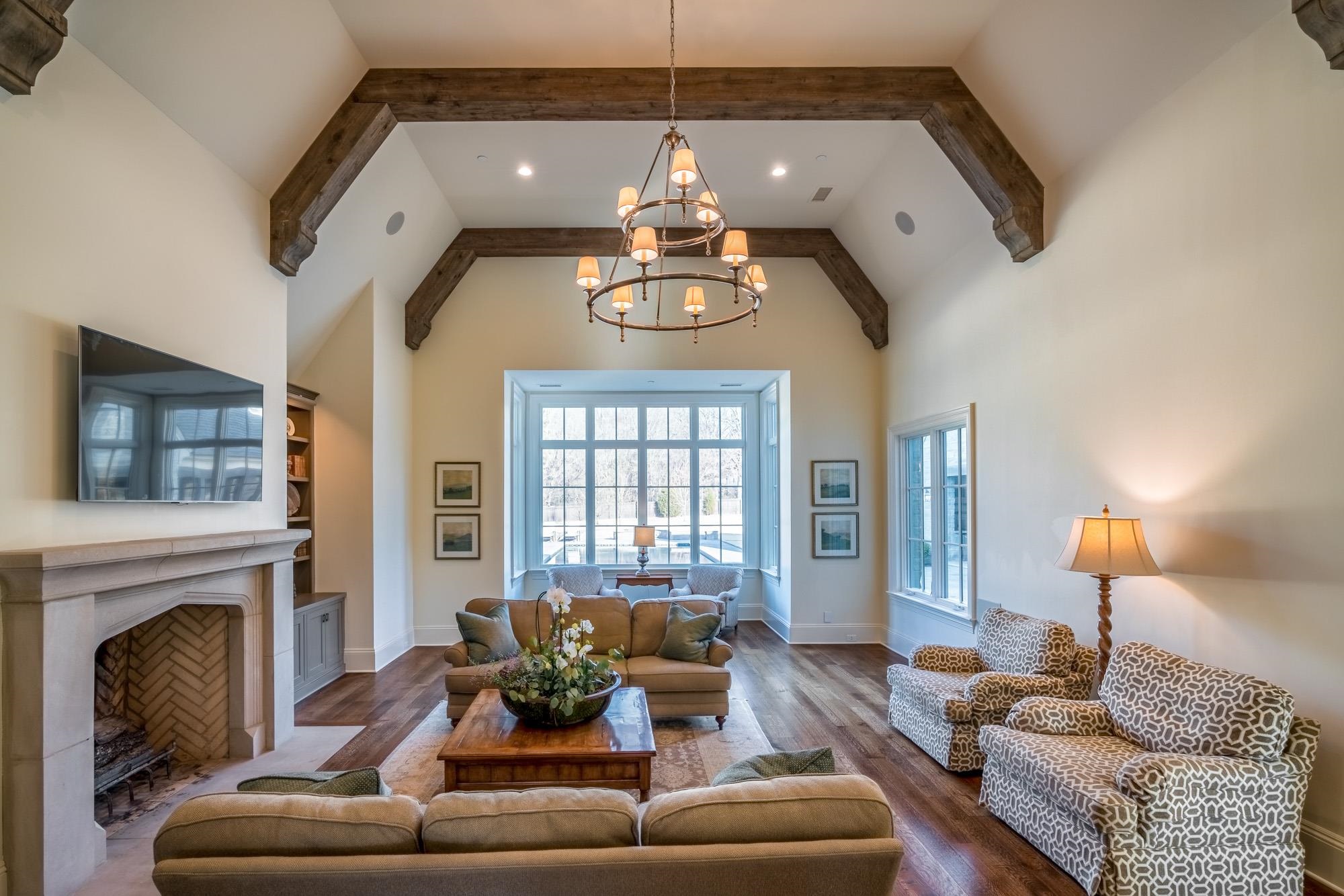 248 Dubray Manor Drive Collierville, TN 38017 - Photo 12 of 25 a living room with furniture a fireplace and a chandelier