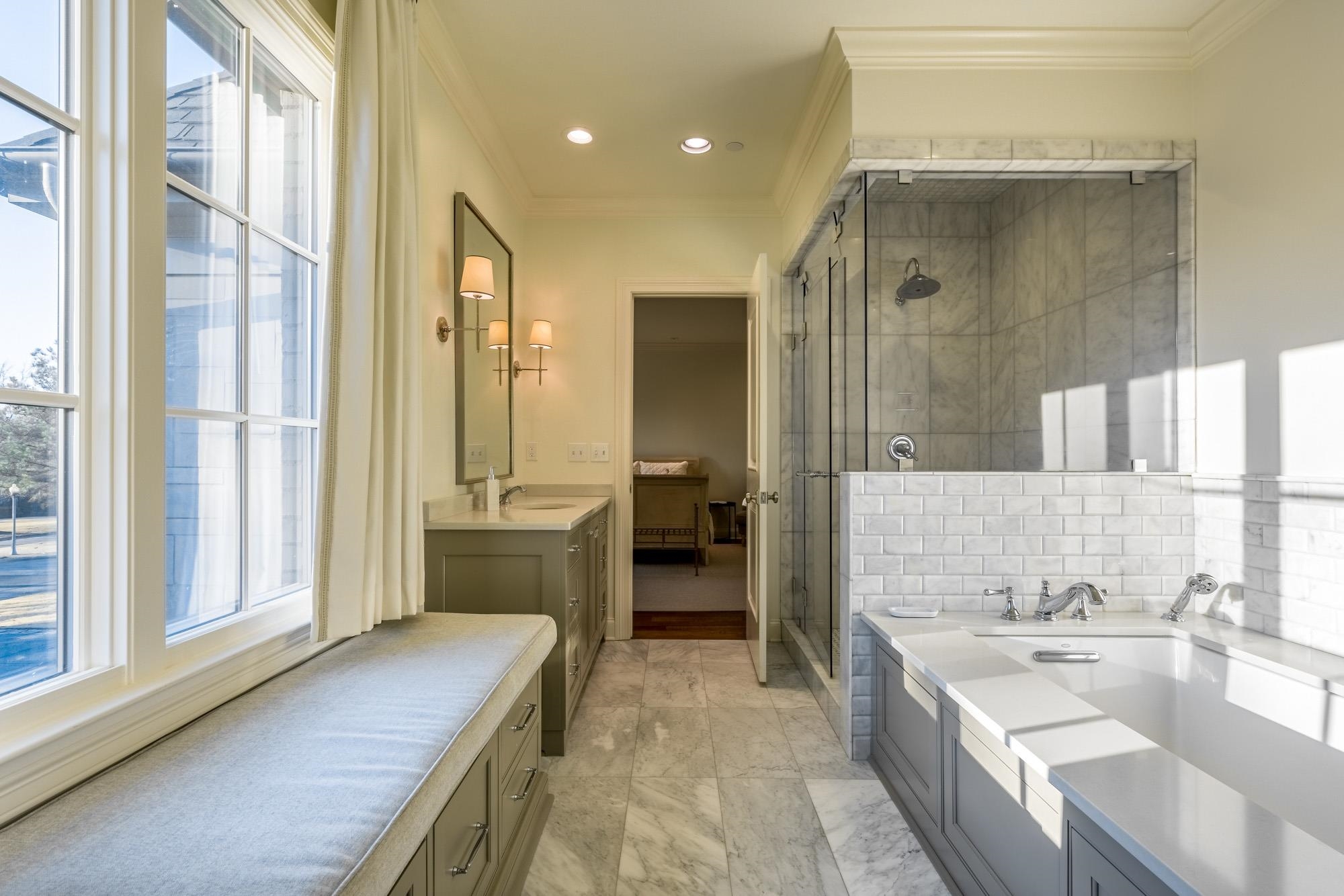 248 Dubray Manor Drive Collierville, TN 38017 - Photo 17 of 25 a bathroom with a tub a sink and a large mirror
