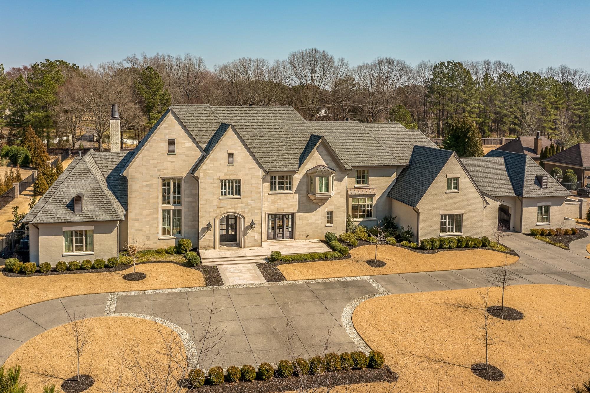 248 Dubray Manor Drive Collierville, TN 38017 - Photo 2 of 25 a view of a white house with a swimming pool and lawn chairs