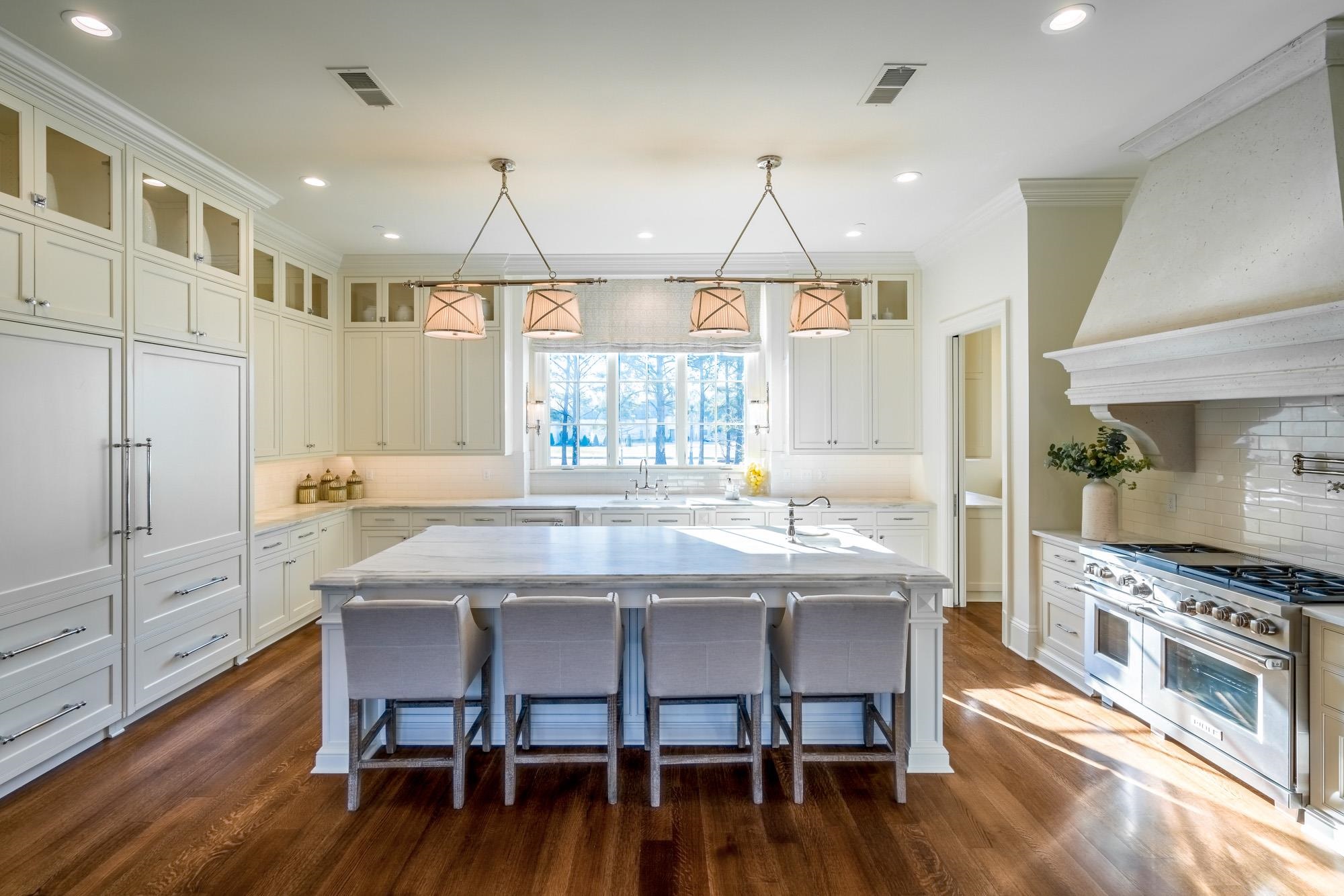248 Dubray Manor Drive Collierville, TN 38017 - Photo 8 of 25 a kitchen with stainless steel appliances a dining table chairs stove and wooden floor