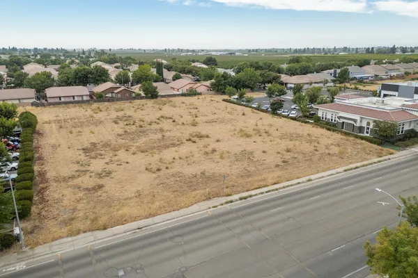 an aerial view of a house with a yard