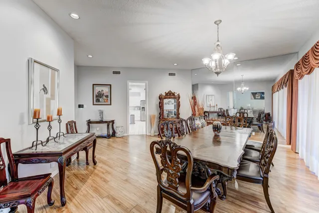 a view of a a dining room with furniture window and wooden floor