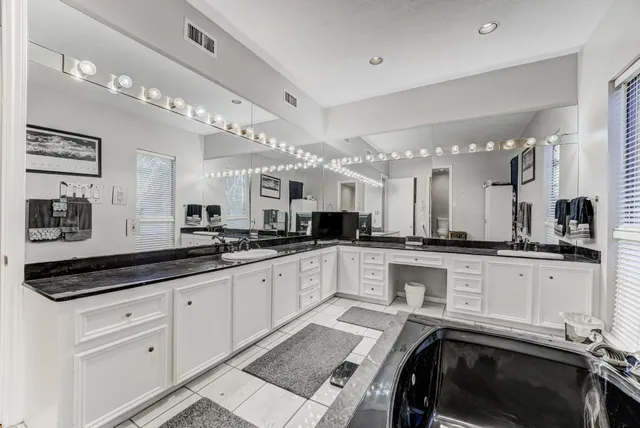 a kitchen with white cabinets and white appliances
