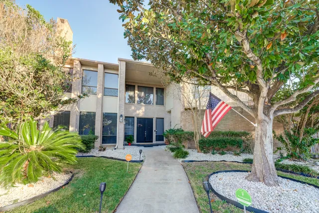a front view of a house with garden