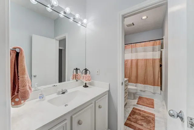 a bedroom with a bed and large windows