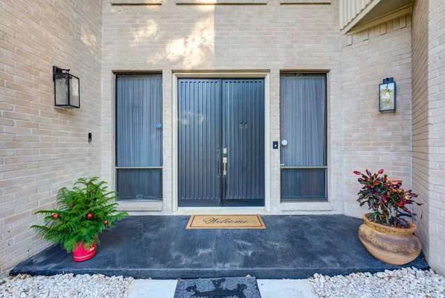 a view of entryway with flower pots