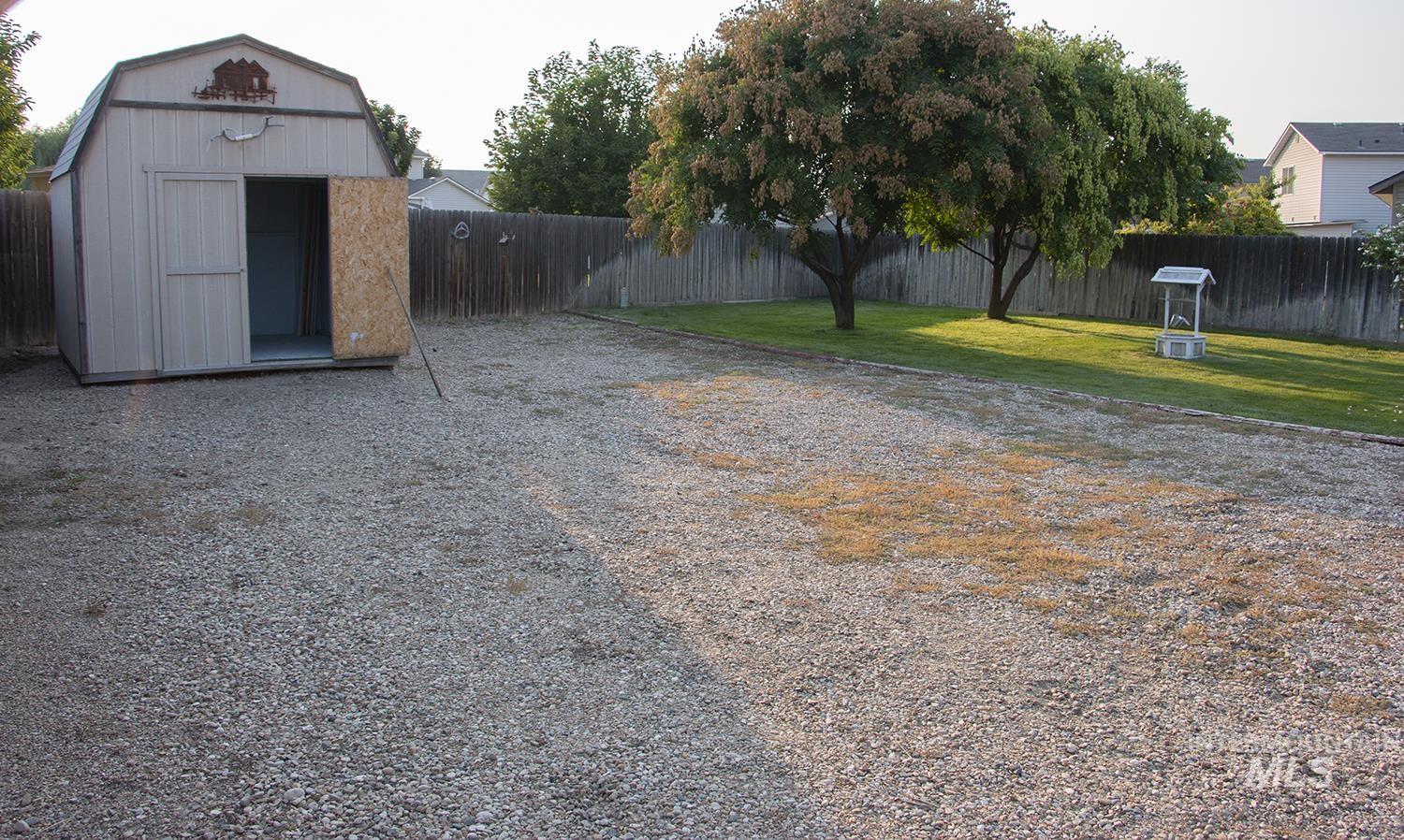 16559 Bayou Way Caldwell, ID 83607 - Photo 16 of 20 Expansive gravel area, wood privacy fencing, and mature trees