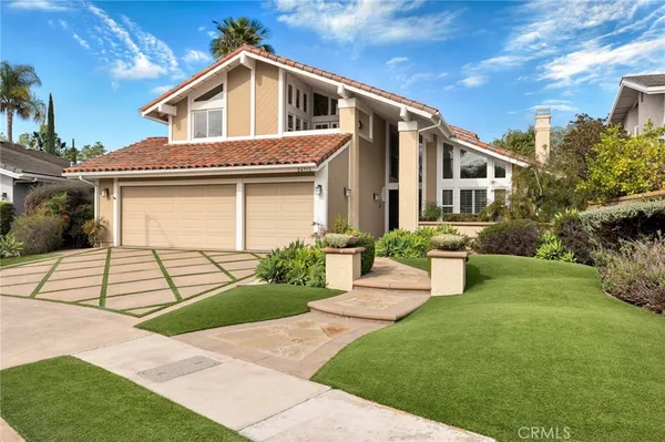 a front view of house with yard and green space