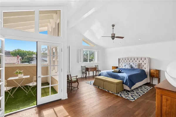 a spacious bedroom with a balcony a bed and a window with balcony view