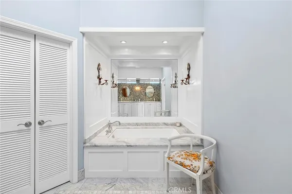 a bathroom with a granite countertop sink and glass door