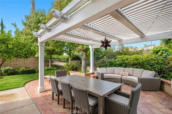 a view of a patio with a table chairs and a backyard