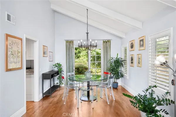 a dining room with furniture window and wooden floor