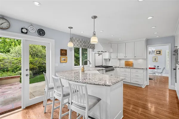 a kitchen with stainless steel appliances granite countertop a stove and refrigerator