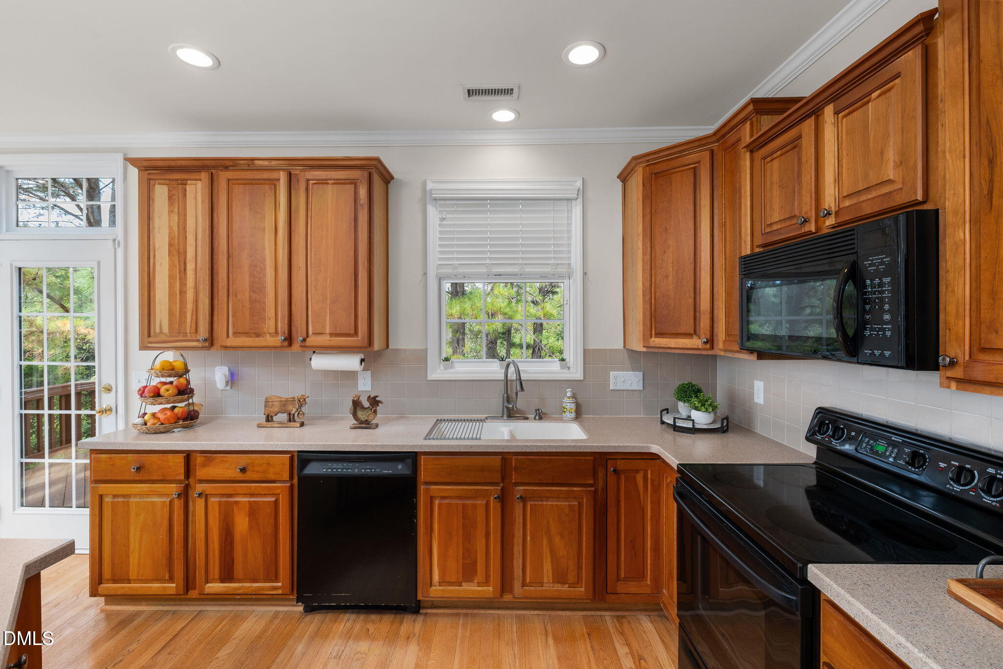 6901 Middleboro Drive Raleigh, NC 27612 - Photo 17 of 42 a kitchen with stainless steel appliances a sink stove and cabinets