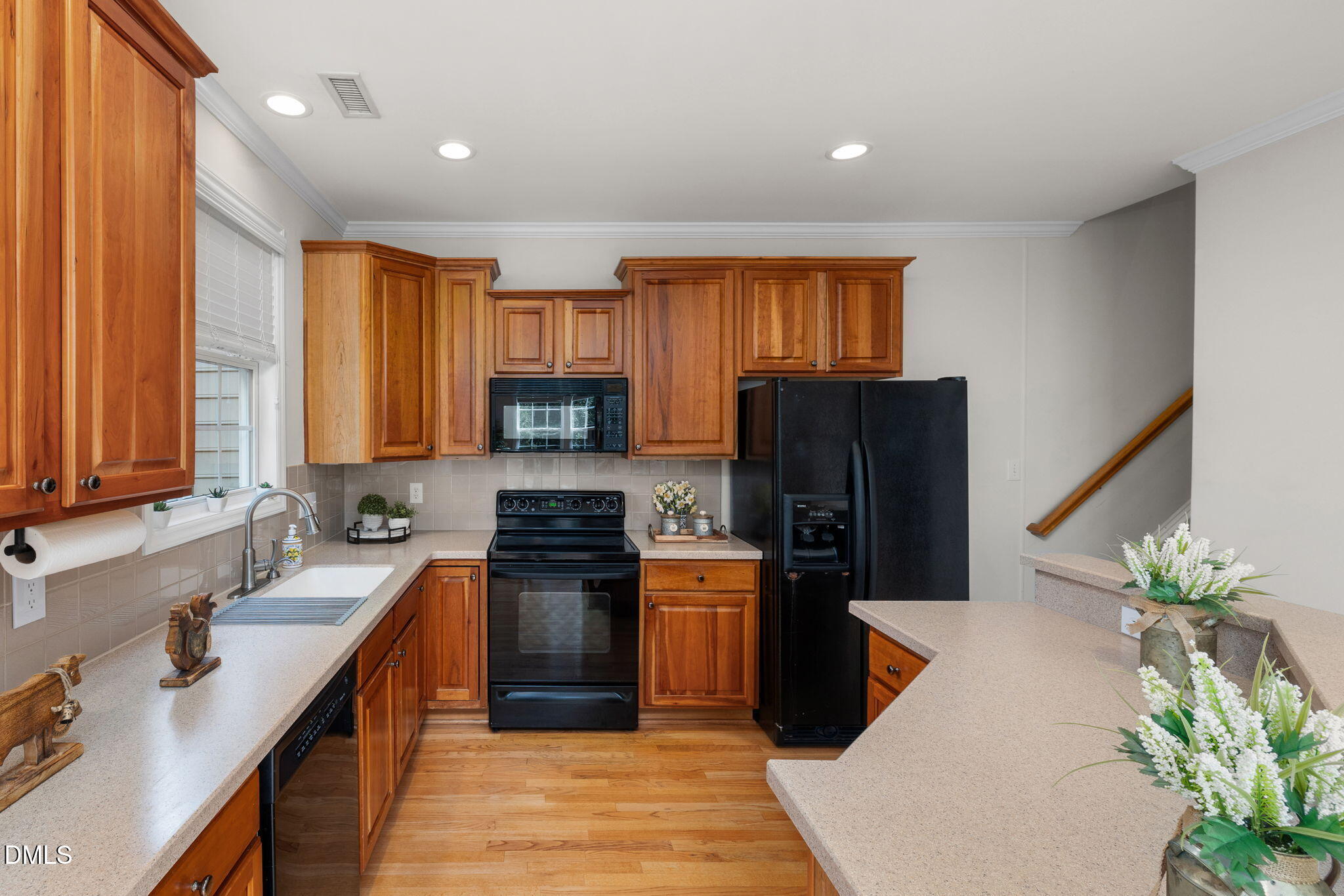 6901 Middleboro Drive Raleigh, NC 27612 - Photo 18 of 42 a kitchen with stainless steel appliances granite countertop a refrigerator a sink a stove a microwave and cabinets