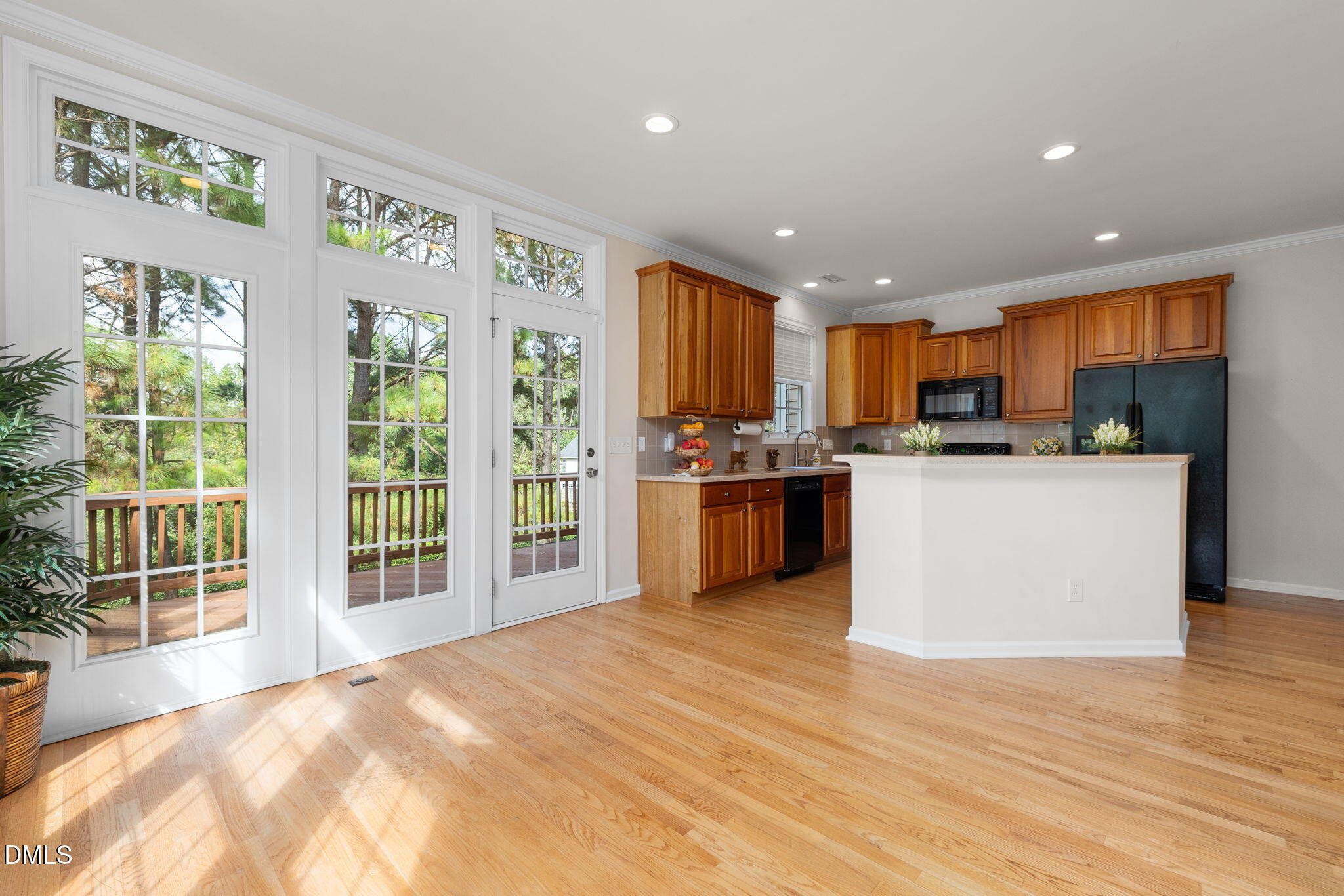 6901 Middleboro Drive Raleigh, NC 27612 - Photo 20 of 42 a kitchen with stainless steel appliances granite countertop a stove top oven a sink dishwasher a refrigerator and a dining table with wooden floor