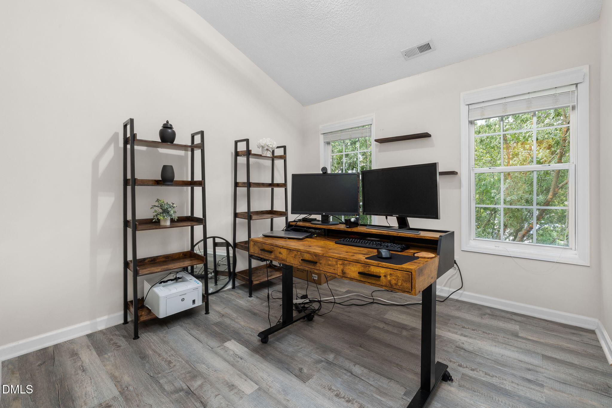 6901 Middleboro Drive Raleigh, NC 27612 - Photo 30 of 42 a living room with furniture a flat screen tv and a window