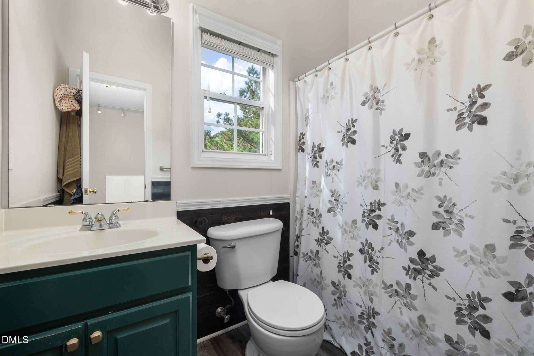 6901 Middleboro Drive Raleigh, NC 27612 - Photo 31 of 42 a bathroom with a sink a toilet and a mirror