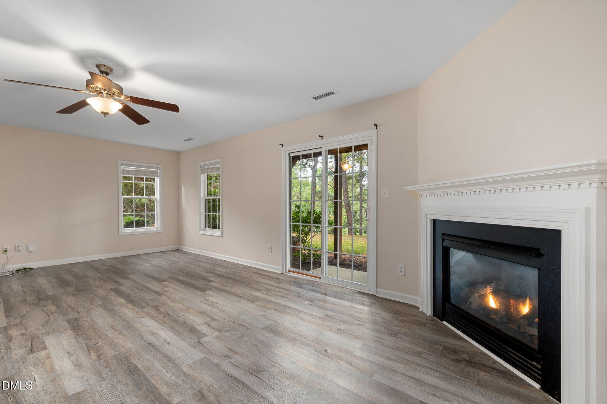 6901 Middleboro Drive Raleigh, NC 27612 - Photo 33 of 42 a view of an empty room with wooden floor fireplace and a window