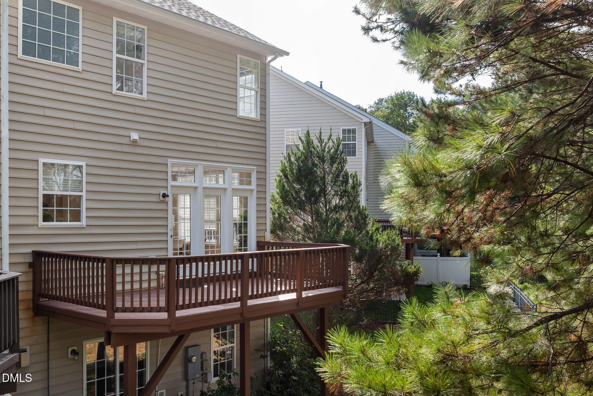 6901 Middleboro Drive Raleigh, NC 27612 - Photo 5 of 42 a view of a wooden balcony and trees