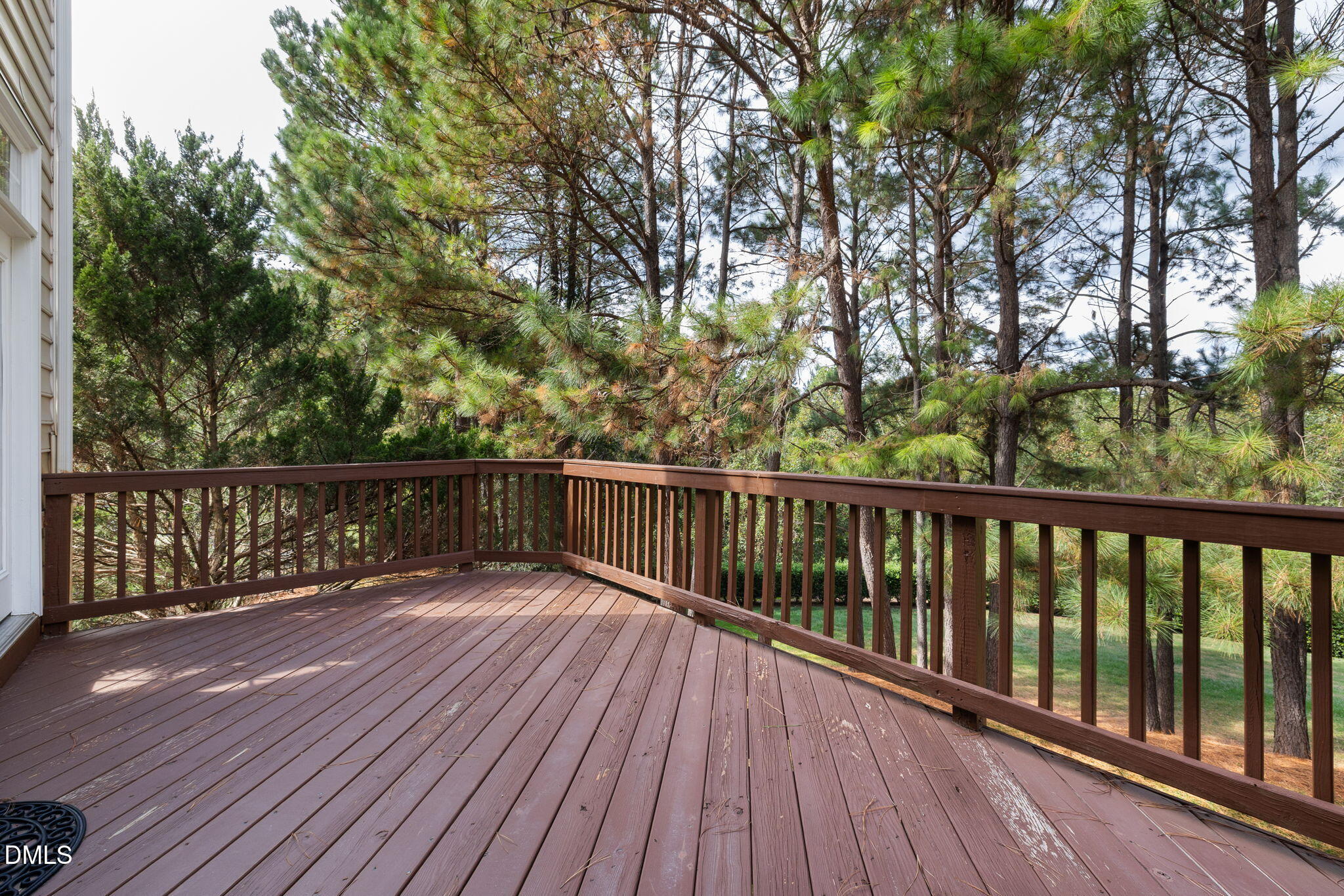 6901 Middleboro Drive Raleigh, NC 27612 - Photo 7 of 42 a balcony with wooden floor and trees
