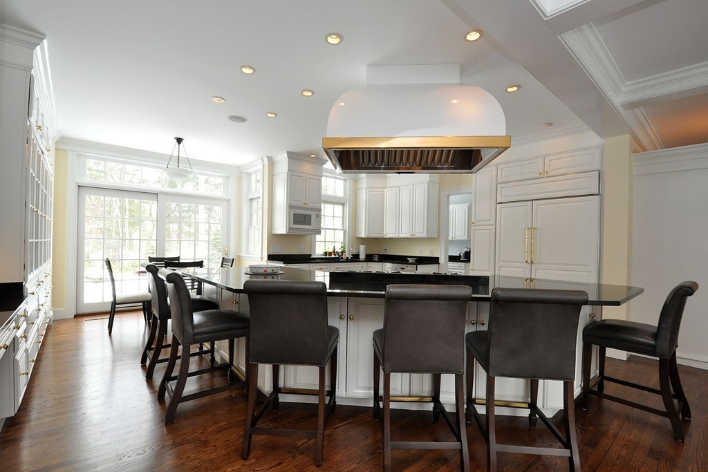 19 Meadowbrook Road Weston, MA 02493 - Photo 18 of 30 a kitchen with granite countertop a dining table chairs and wooden floor
