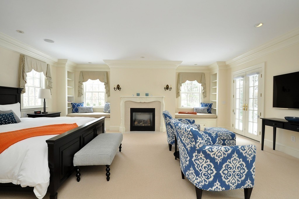 19 Meadowbrook Road Weston, MA 02493 - Photo 19 of 30 a spacious bedroom with a bed and a fireplace
