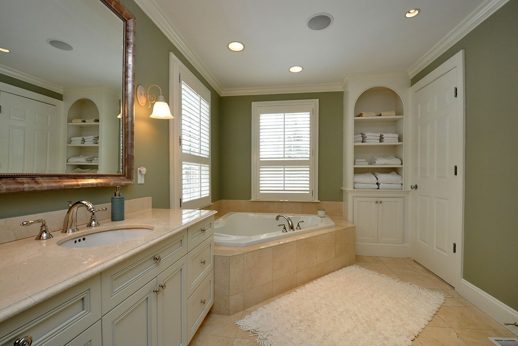 19 Meadowbrook Road Weston, MA 02493 - Photo 21 of 30 a bathroom with a tub a double vanity sink a mirror a window and a shower