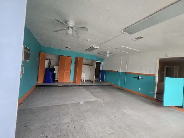 a view of a livingroom with an empty space and a window