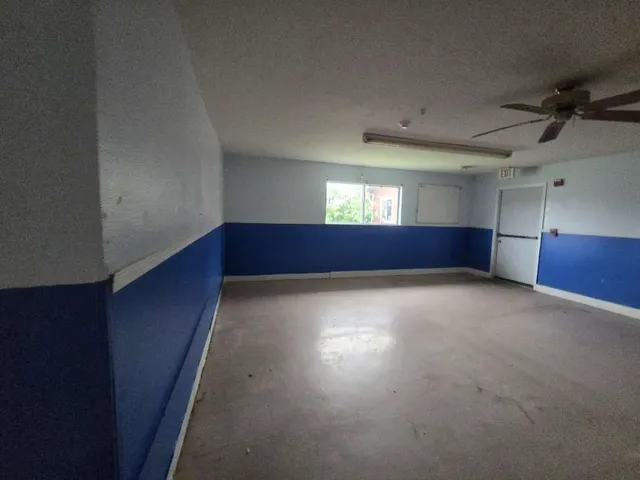 a view of an empty room with windows