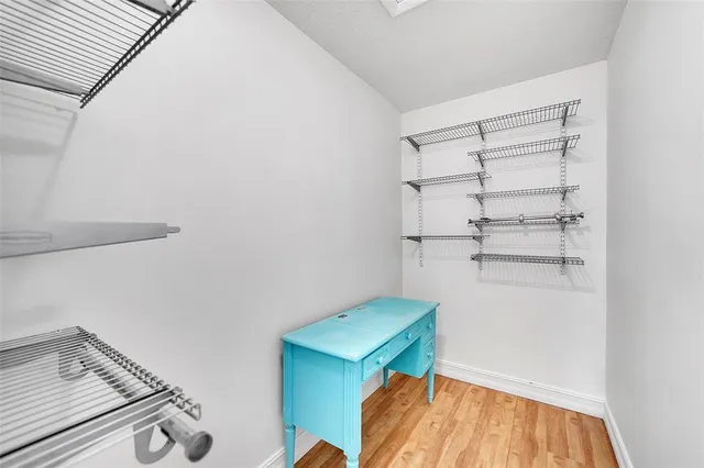 a view of storage and utility room with racks on the wall