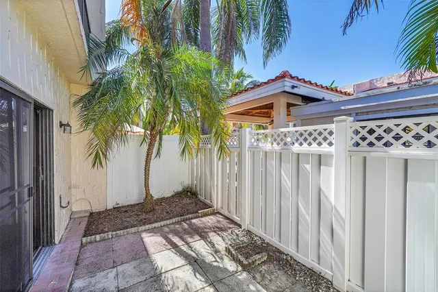 a view of a house with a small yard and plants