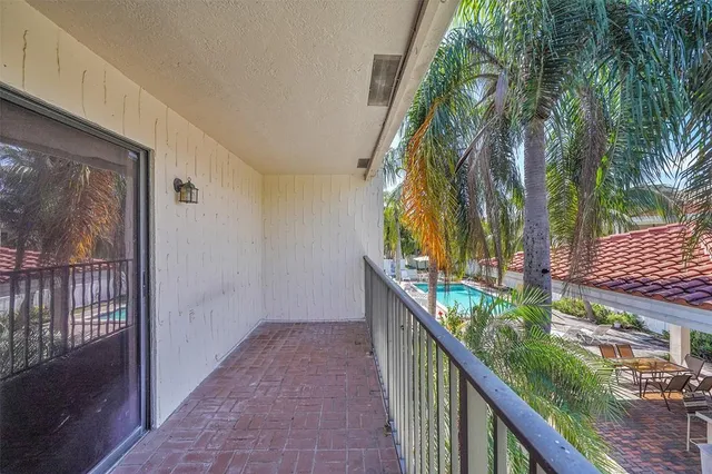 a view of balcony with wooden floor and fence
