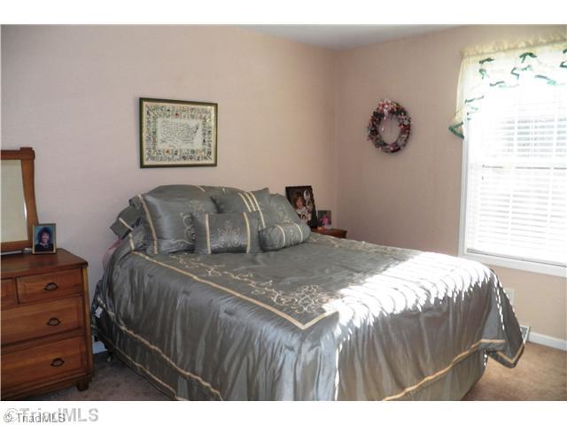 485 Riverview Rd Extension Lexington, NC 27292 - Photo 12 of 16 2nd Bedroom. Bedroom #2 with large walk-in closet. Window to backyard. Hall bath with tub right next to this bedroom