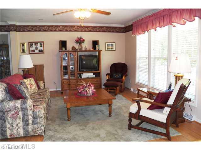 485 Riverview Rd Extension Lexington, NC 27292 - Photo 6 of 16 Living Room. Open concept living room, dining and kitchen area. 3 Large windows in living room for view of front porch and lake across the street. Laminate floor with area rugs. Tile entry area at front door.