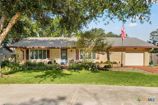 a front view of a house with a yard and sitting area