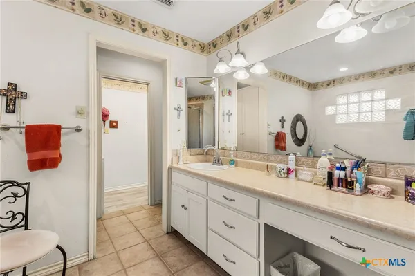 a bathroom with a double vanity sink mirror and shower