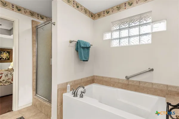 a bathroom with a bathtub and a shower