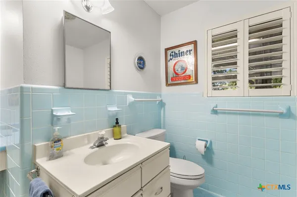 a bathroom with a sink a vanity and a window