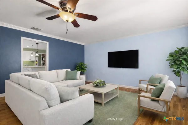 a living room with furniture and a flat screen tv