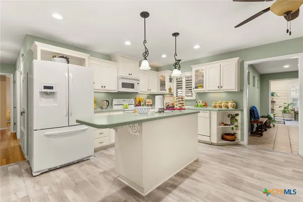 a kitchen with stainless steel appliances a refrigerator sink and microwave