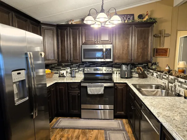 a kitchen with a refrigerator and a sink