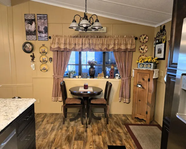 a bed sitting in a bedroom and chandelier