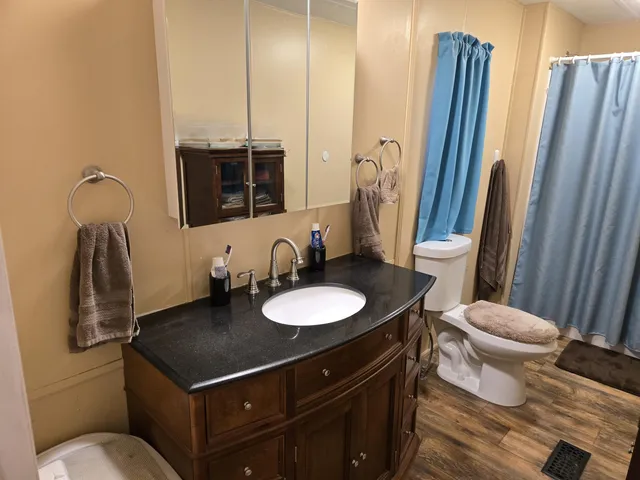 a bedroom with a bed and a mirror