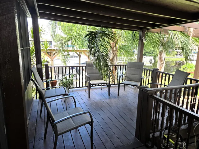 an aerial view of a house with a garden and lake view