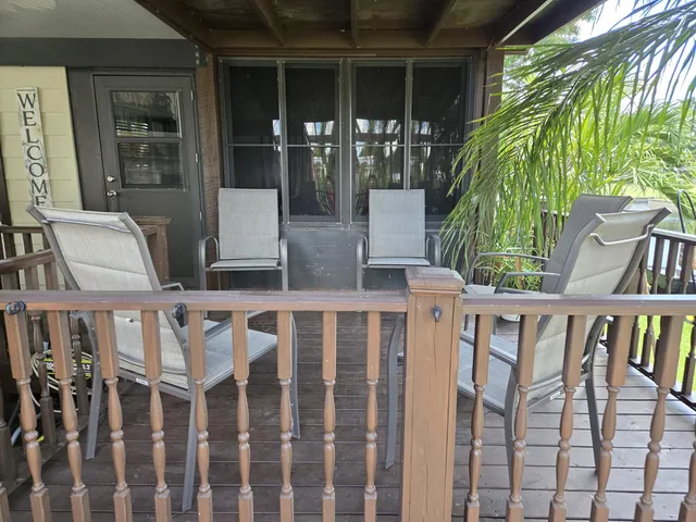 an aerial view of a house with a garden and lake view